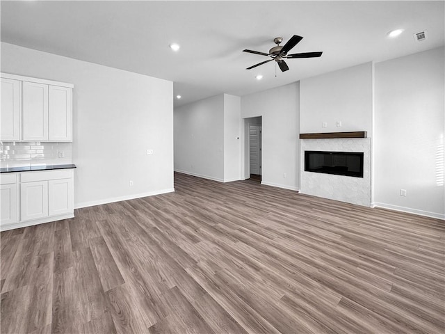 unfurnished living room featuring light hardwood / wood-style floors and ceiling fan