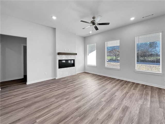 unfurnished living room with ceiling fan and light hardwood / wood-style floors