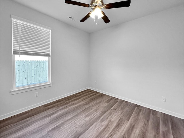 empty room with hardwood / wood-style floors and ceiling fan