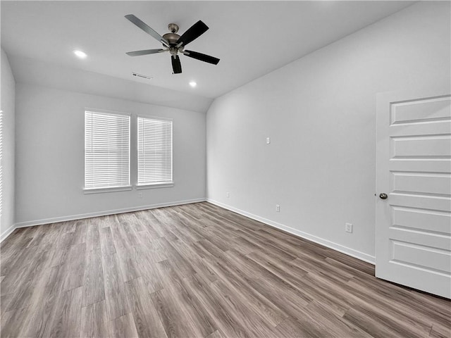 unfurnished room featuring ceiling fan, lofted ceiling, and light hardwood / wood-style floors