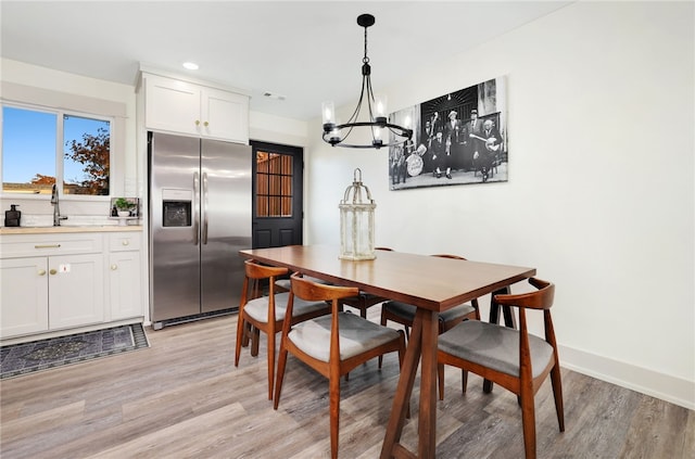 dining space featuring light hardwood / wood-style floors and sink