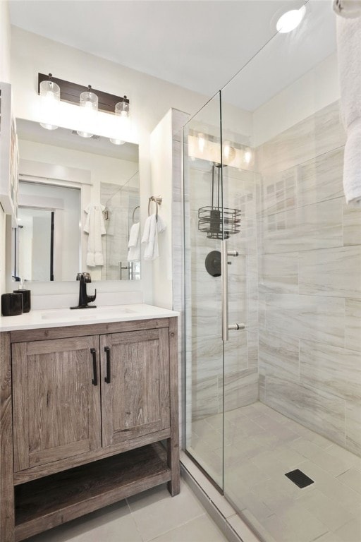 bathroom featuring vanity, a shower with shower door, and tile patterned floors