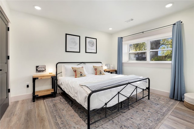 bedroom with wood-type flooring