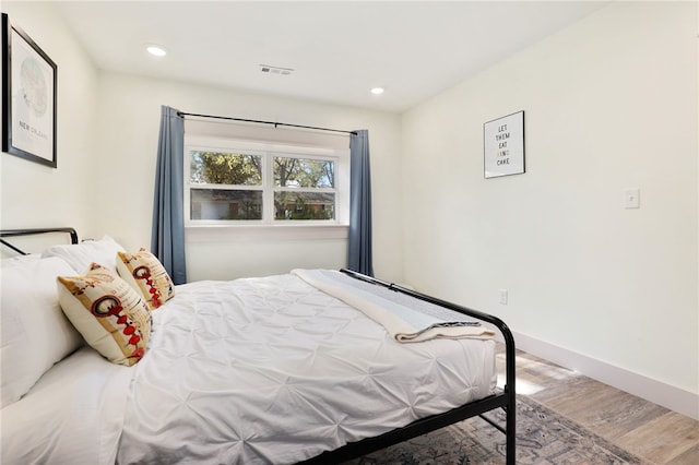 bedroom with hardwood / wood-style flooring