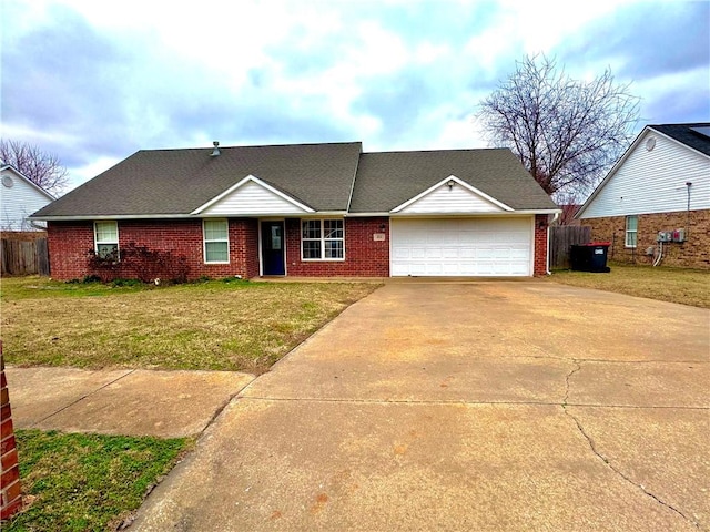 single story home featuring a garage and a front yard