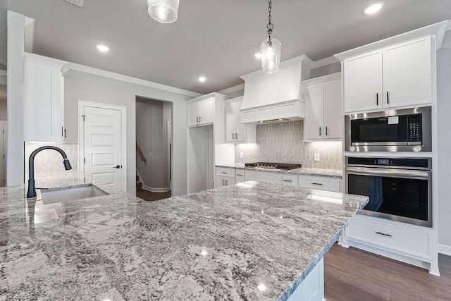 1440 Tiffany St, Centerton, AR 72719 - kitchen featuring stainless steel appliances, recessed lighting, ornamental molding, white cabinets, and light stone countertops