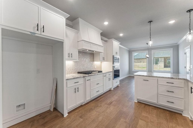 1440 Tiffany St, Centerton, AR 72719 - kitchen featuring stainless steel appliances, custom exhaust hood, white cabinetry, crown molding, and wood finished floors