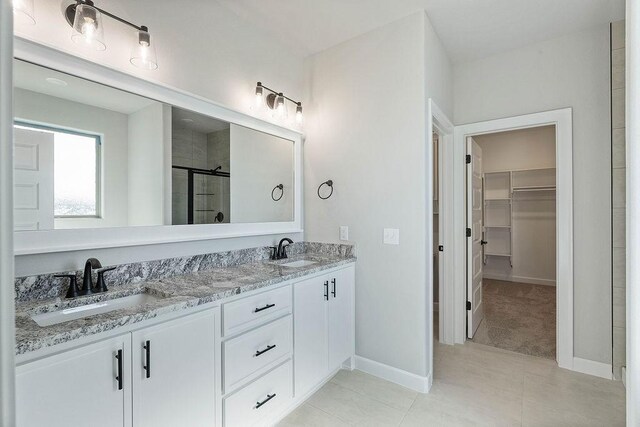 1440 Tiffany St, Centerton, AR 72719 - full bath featuring a walk in closet, a shower stall, double vanity, and tile patterned floors