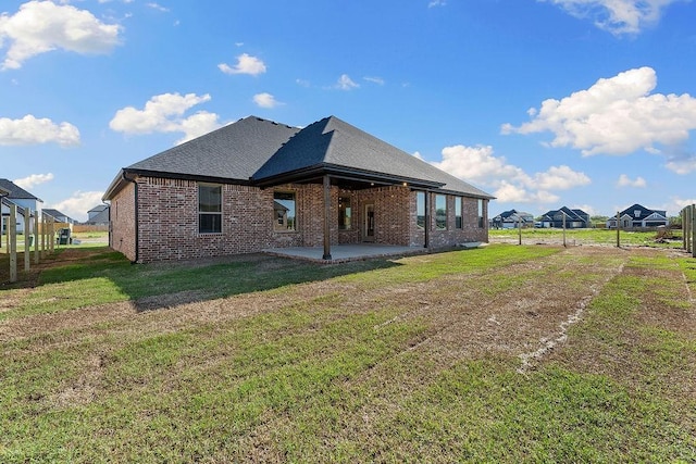 1440 Tiffany St, Centerton, AR 72719 - rear view of property featuring brick siding, a patio, and a shingled roof