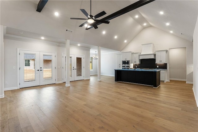 kitchen with visible vents, premium range hood, open floor plan, french doors, and stainless steel appliances