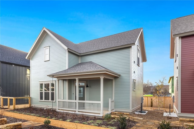 rear view of house with a porch