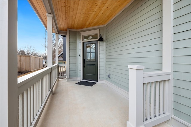 view of exterior entry featuring covered porch