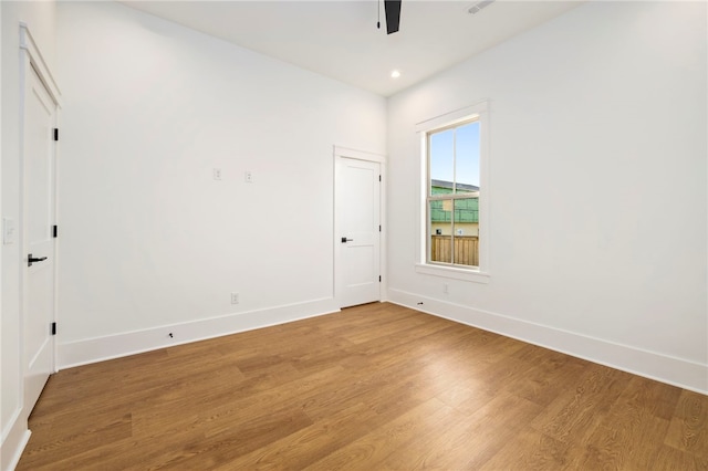 unfurnished room with light wood-style flooring, baseboards, and ceiling fan