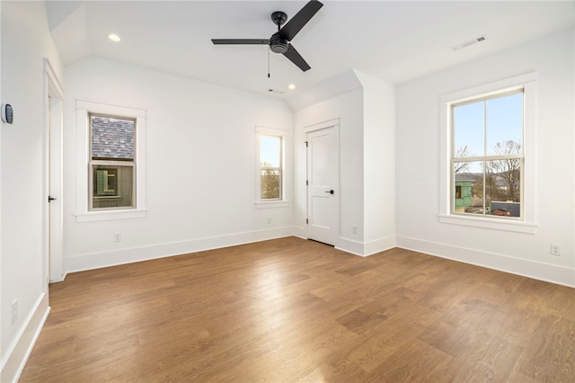 unfurnished bedroom with recessed lighting, wood finished floors, baseboards, and vaulted ceiling