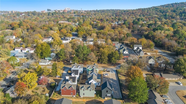 birds eye view of property featuring a residential view and a wooded view