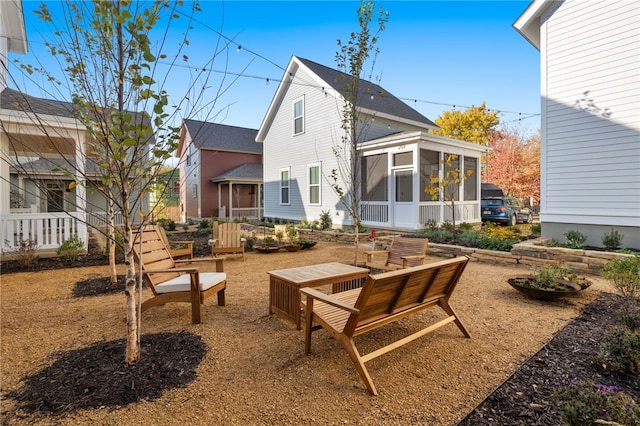 rear view of house featuring a sunroom