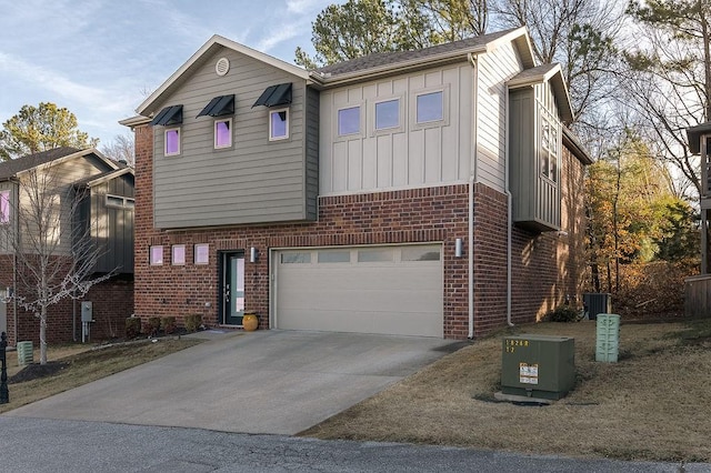 view of front of property featuring a garage and central AC