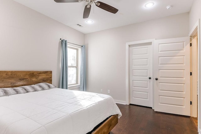 bedroom with dark hardwood / wood-style floors and ceiling fan