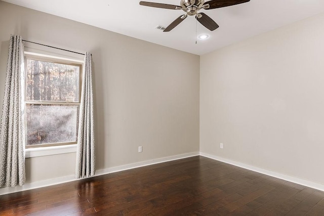 spare room with ceiling fan and dark hardwood / wood-style flooring