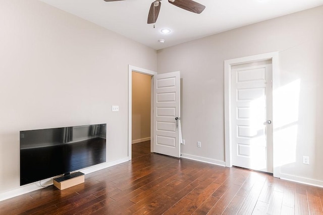 unfurnished bedroom with ceiling fan and dark hardwood / wood-style floors