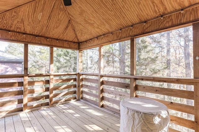 unfurnished sunroom with lofted ceiling, wood ceiling, and a wealth of natural light