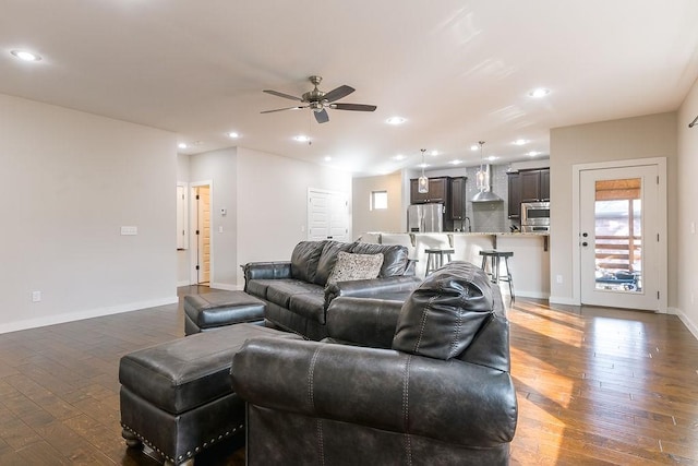 living room featuring dark hardwood / wood-style floors and ceiling fan