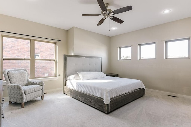 bedroom with light colored carpet and ceiling fan