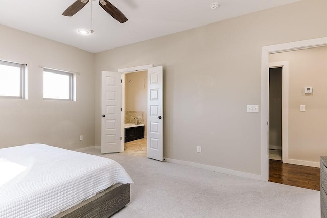 carpeted bedroom featuring connected bathroom and ceiling fan