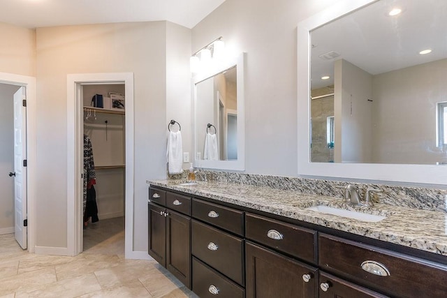 bathroom featuring vanity and an enclosed shower