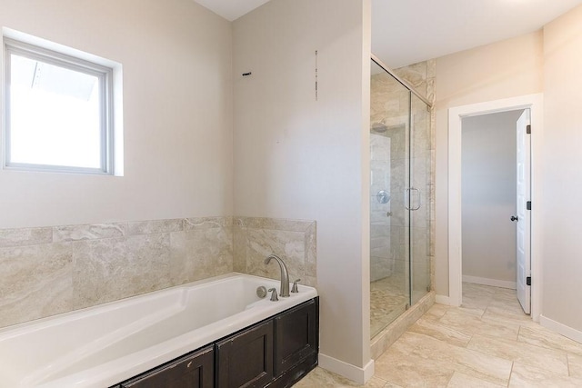 bathroom featuring separate shower and tub