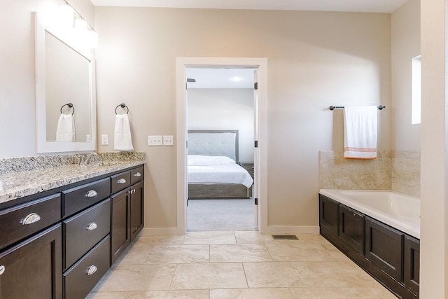 bathroom with vanity and a tub