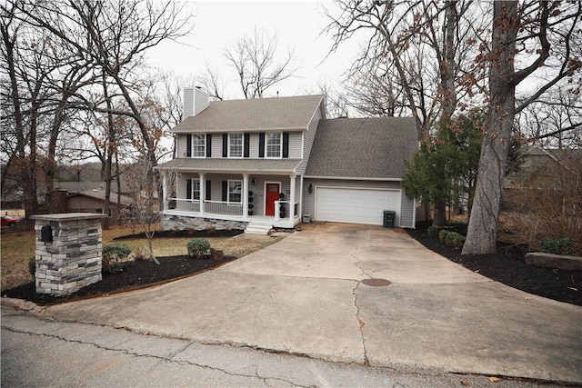 colonial inspired home featuring a garage, central AC unit, and covered porch