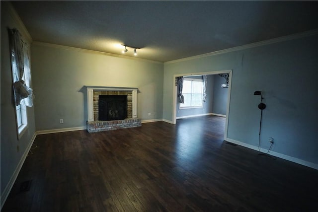 unfurnished living room featuring ornamental molding, dark wood-type flooring, and a fireplace