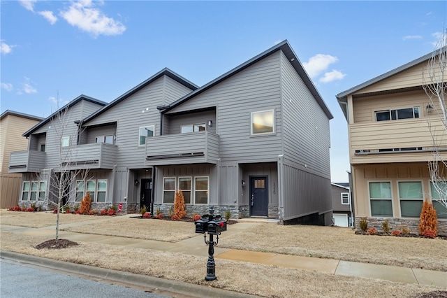 multi unit property with stone siding and board and batten siding