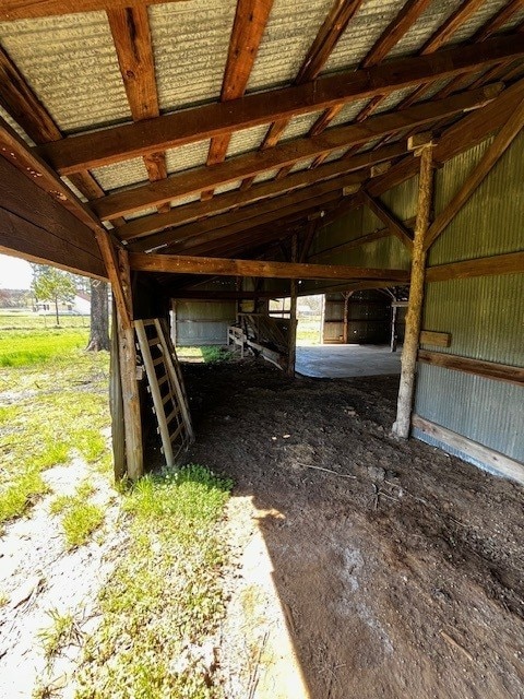 interior space featuring a carport and an exterior structure