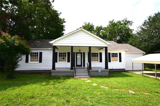 view of front of property featuring a front yard, a carport, and covered porch