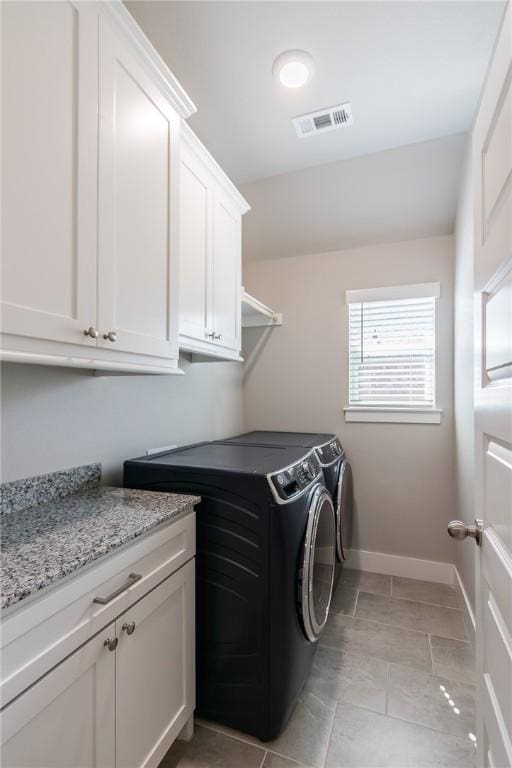 laundry room featuring cabinet space, visible vents, baseboards, and separate washer and dryer