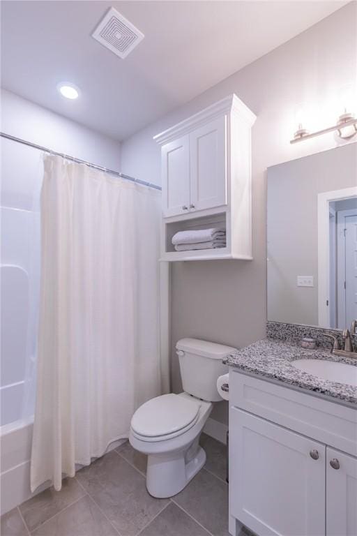 bathroom featuring visible vents, toilet, shower / bath combo with shower curtain, vanity, and tile patterned floors