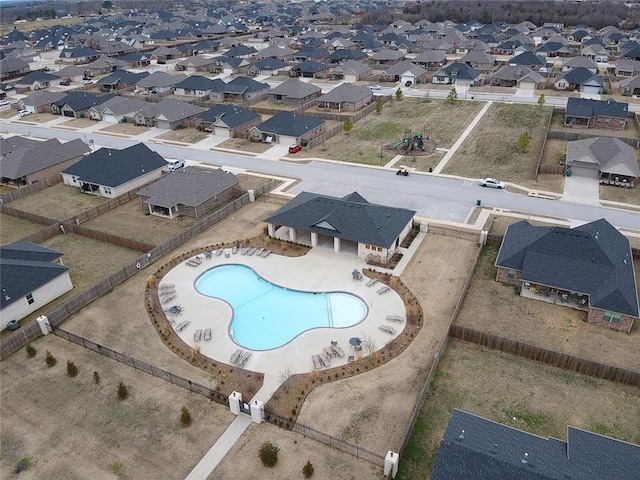 view of swimming pool with a residential view and fence