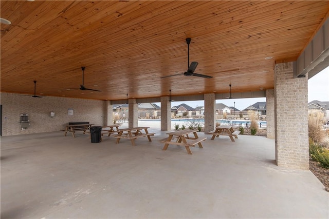 view of patio / terrace with a ceiling fan and a community pool