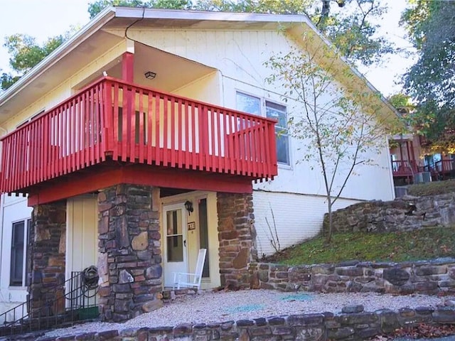 view of side of property with a balcony