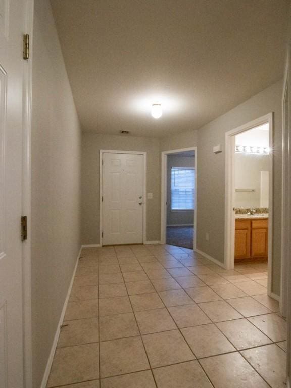 corridor featuring light tile patterned floors