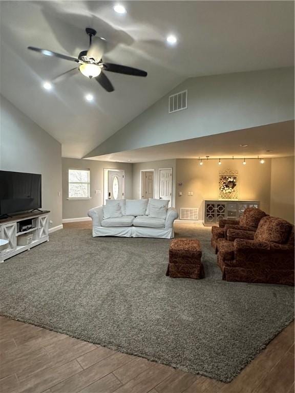 living room with hardwood / wood-style floors, high vaulted ceiling, and ceiling fan