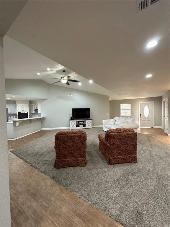 living room featuring lofted ceiling and ceiling fan