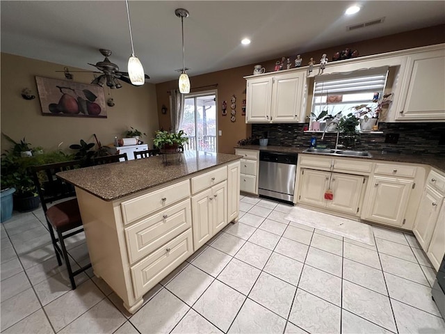 kitchen with backsplash, dark stone counters, hanging light fixtures, a center island, and stainless steel dishwasher