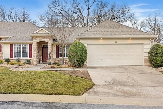 view of front of property featuring a garage and a front lawn