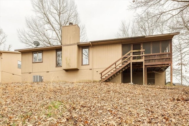 rear view of property with cooling unit and a sunroom