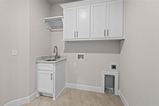 laundry area with hookup for a washing machine, sink, hookup for an electric dryer, and cabinets