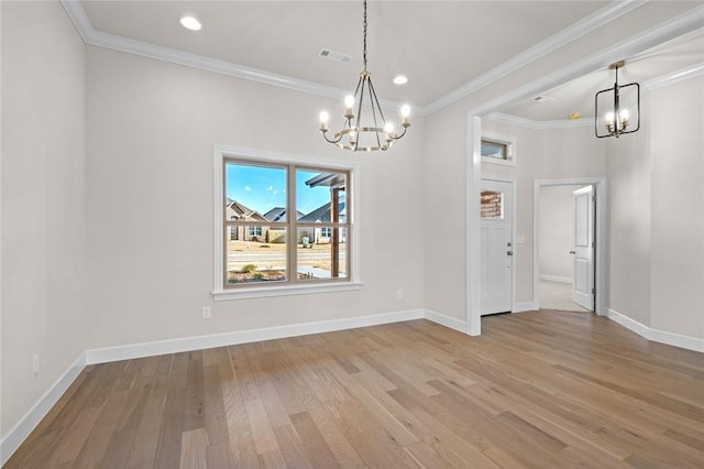 unfurnished dining area featuring an inviting chandelier, hardwood / wood-style flooring, and ornamental molding