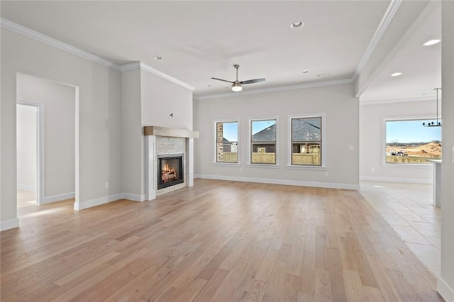 unfurnished living room with ornamental molding, ceiling fan, and light hardwood / wood-style flooring